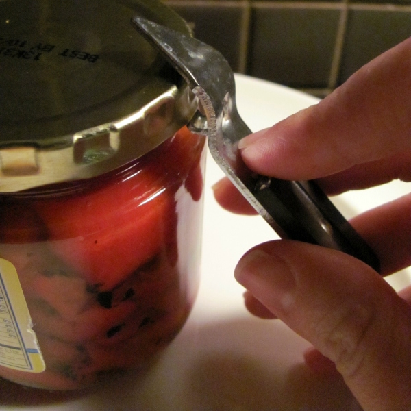 Use a bottle opener to pry open a stuck jar top