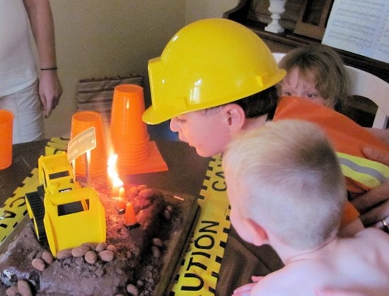 Blowing out candles on Construction Cake