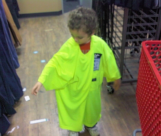 Boy trying on construction shirt