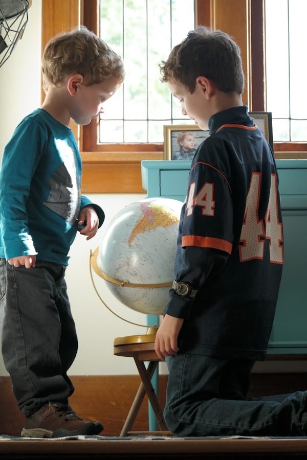 Boys studying a globe